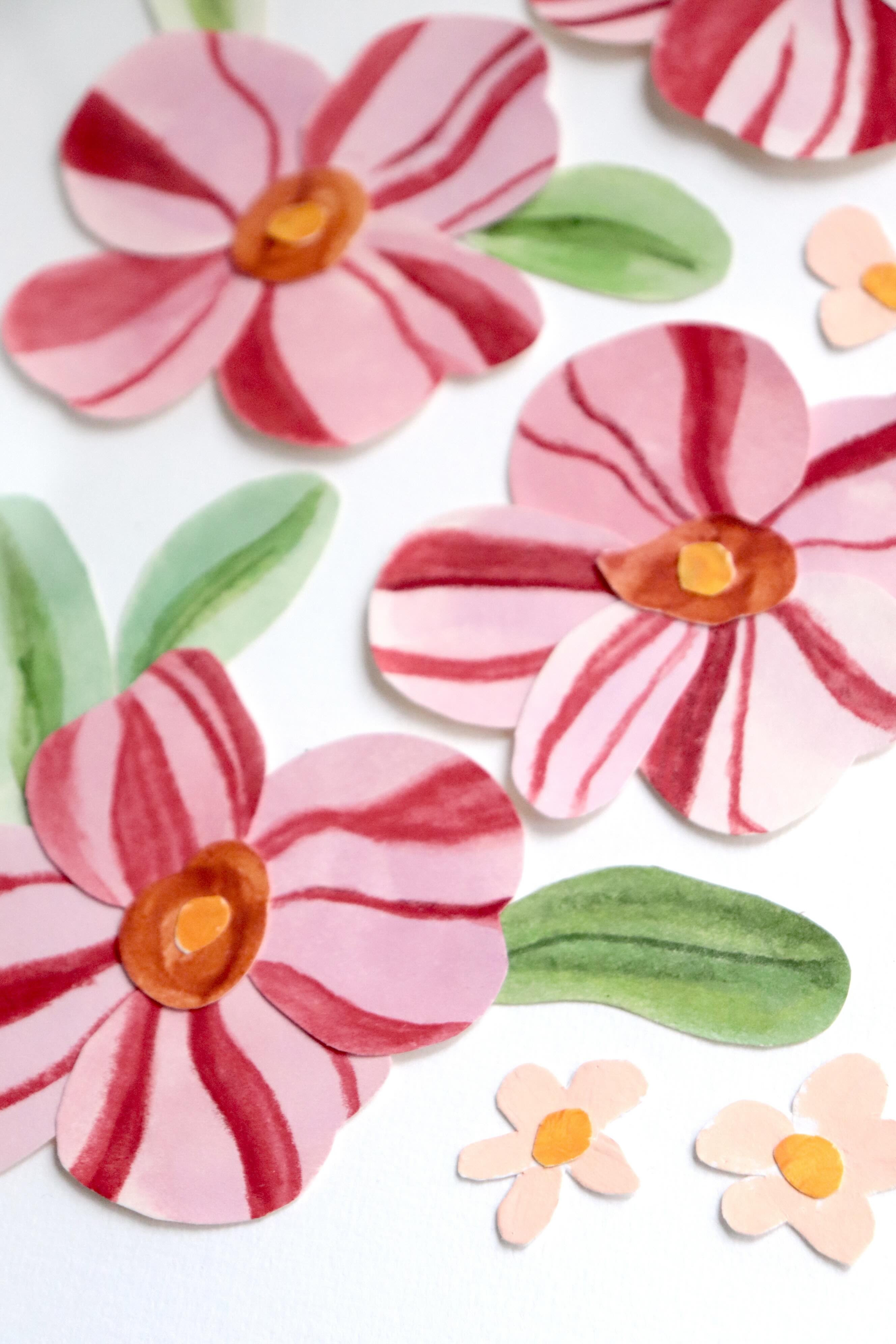 herbier de papier nommé Dragée, collage de fleurs en papier rose et rouge en relief sur fond blanc immaculé, encadré dans un cadre en bois rose, création Chemin des Marettes.